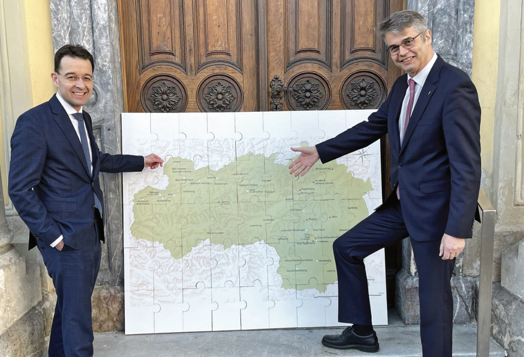 V. l.: Superintendentialkurator Michael Axmann und Superintendent Wolfgang Rehner mit einer Karte, die die 35 Pfarrgemeinden der Evangelischen Kirche in der Steiermark zeigt.